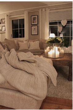 a living room filled with furniture and candles