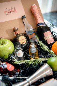 an assortment of liquors and condiments in a gift box on a table