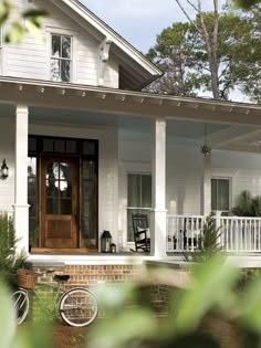 a bicycle is parked on the front porch of a house