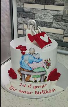 a cake decorated with an elderly couple sitting on a bench and holding the keys to each other