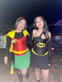 two girls dressed in costumes standing next to each other