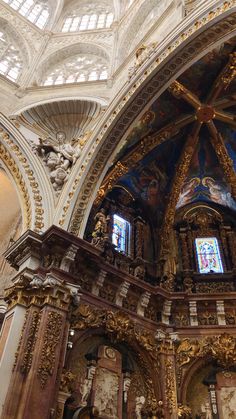 the interior of an ornate church with stained glass windows