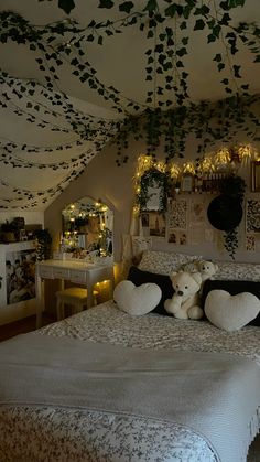 there is a bed with two teddy bears on it and lights hanging from the ceiling