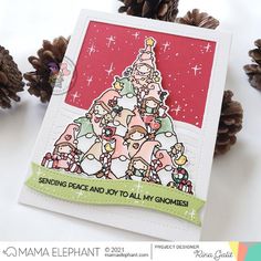 a handmade christmas card with pine cones on the side and an image of a tree