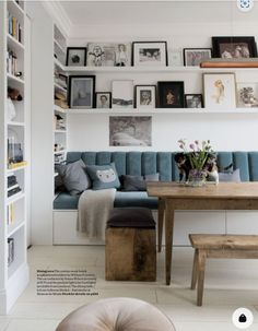 a living room filled with furniture and lots of pictures on the wall above it's couch