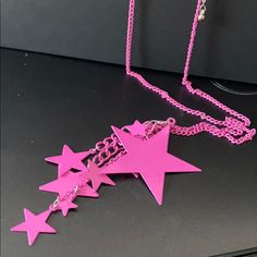 Neon Pink Retro Disco Star Necklace. 22” Pink Chain With 3” Extender. 10 Stars In Assorted Sizes Drop About 3.5” In Y Cleavage. Party Necklaces With Star Charm, Trendy Star Embellished Jewelry For Parties, Trendy Party Necklace With Star Charm, Party Necklace With Star Charm, Trendy Star Embellished Party Jewelry, Party Dangle Necklaces With Star Charm, Party Necklace With Star Charm Dangle, Pink Metal Chain Necklace For Party, Party Star Necklace With Adjustable Chain