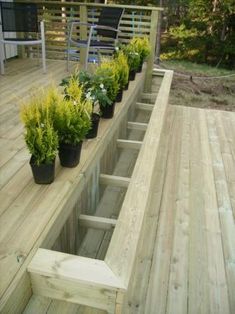 a wooden deck with potted plants on it