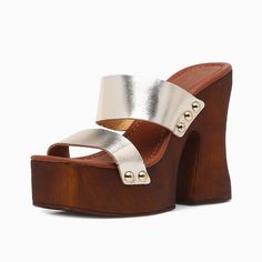 Gleaming in gold and brown hues, these open-toe chunky heel mules boast a platform for added elegance. A striking blend of style and comfort for versatile fashion statements. Color: Gold Brown Heel Type: Chunky heel Heel Height: 5'' / 127 mm approx Platform Height: 2'' / 50 mm approx Product measurements were taken using size 8. Please note that measurements may vary by size. Toe: Open square toe Metal straps design Studded design Handcrafted US sizing. Fits true to size. Sandals With Platform, Mules Sandals, Flat Wedges, Heeled Mules Sandals, Heel Mules, Fashion Statements, Metal Straps, Brown Heels, Mule Sandals