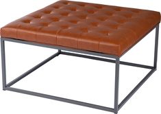 a brown leather ottoman sitting on top of a metal frame