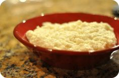 a red bowl filled with food on top of a counter