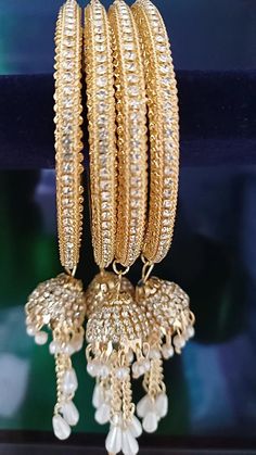 Gold Plated Finish Premium Quality American Diamond/CZ Bangles/ CZ Bbraceletss/ Party Wear Bangles/ CZ Stone bangles/Wedding/bridal jewelry Sold as Set of 4 pieces. Premium Quality Gold Plated Finish American Diamond Jhumki with Pearl Drops is a perfect gift, for party wear, weddings, and special occasions. Sizes - 2.4, 2.6 and 2.8 inches. Jeweled Bracelets For Wedding And Diwali, Festive American Diamond Bracelets With Stone Work, Festive American Diamond Bracelet With Stone Work, White Bracelet With Stone Work For Celebration, Traditional Jeweled Bangle For Festive Occasions, Jeweled Bangle For Wedding And Diwali, Gold Bangle With Jewels For Weddings, Gold Jeweled Bangle For Wedding, White Bollywood Bracelet With Stone Work