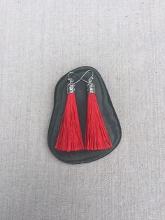 "Chic red tassel earrings! They would add a pop of color to any outfit for any occasion. Dress them up or down. They are timeless and versatile. They are lightweight, fun and unique! The tassels measure 2 1/8\" long by 1/4\" wide. They hang from simple silver ear wire hooks. Overall drop length is about 2 1/4\". Metal is allergy free plated silver. These are my latest creation! I have them available in many colors! Find them all under the category tassel earrings in my shop. Thanks for stopping Red Earrings With Latkans For Gift, Red Dangle Earrings With Latkans, Red Latkans Earrings Gift, Red Latkans Earrings For Gift, Red Dangle Tassel Earrings As Gift, Red Fringe Tassel Earrings As Gift, Red Tasseled Jewelry As A Gift, Red Tassel Earrings With Fringe For Gift, Red Tassel Drop Earrings Gift