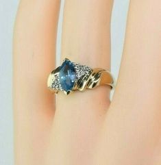 Vintage 14K Yellow gold Blue Topaz Diamond Accent Ring, medium blue central marquise cut 5x10mm faceted stone, white gold set, 2 accent diamonds bypass design, 3/8 inch across, Ring size 6.75, Circa 1965, 3.5 grams. SKU # BB271R09 Most rings are sizable for a small fee. If the ring you are considering is the incorrect size contact us for a quote. This listing contains photographs of the actual item you will receive. Our items are in excellent condition with little or no signs of wear and many ar Diamond Accent Ring, White Gold Set, Marquise Cut, Gold Set, Medium Blue, Blue Topaz, Floral Rings, Topaz, Ring Size