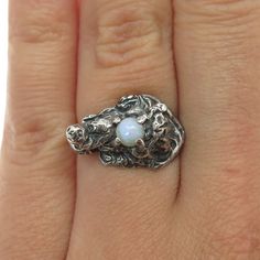 Great vintage condition.  925 Sterling Silver Vintage Real White Opal Gem Brutalist Oxidized Ring Size 6.5  Weight: 4.2g   WELCOME TO PAWN SHOP We are an actual pawn shop and have been in business for over 25 years. Since 1990, our establishment has been serving a variety of clients by providing them with short term cash solutions and options of liquidity regarding their treasured heirlooms. Acknowledging that today′s customers are very sophisticated and are looking for a variety of investments, Heirloom Sterling Silver Moonstone Ring For Formal Occasions, Heirloom Style Sterling Silver Moonstone Ring For Formal Occasions, Silver Birthstone Rings Collectible, Silver Birthstone Rings For Collectors, Heirloom Style Silver Opal Ring, Heirloom Silver Opal Ring, Antique Silver Opal Gemstone Ring, Collectible Silver Opal Ring, Heirloom Silver Moonstone Ring For Formal Occasions