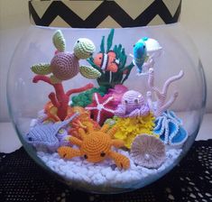 a fish bowl filled with crocheted sea creatures