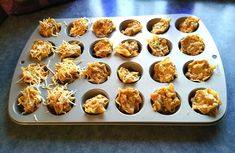 a muffin tin filled with lots of different types of food