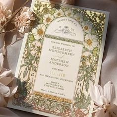 an ornate wedding card with flowers on the bottom and in the middle, surrounded by silk