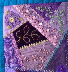 a close up of a quilted wall hanging with numbers and flowers on it's side