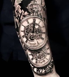 a man's arm with a clock tattoo on it