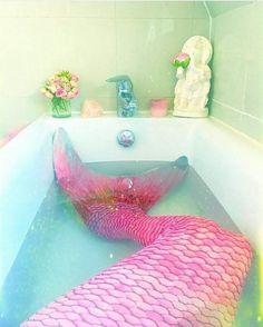 a pink and blue mermaid tail in a bathtub