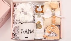 a gift box containing a mug, teddy bear and other items