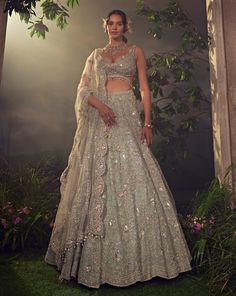 Featuring a jade green organza lehenga embellished with Japanese bugle beads, pearls, sequences and dori embroidary. Paired with a linear jaal embroidered dupatta and a stylised blouse accentuated with pearl dropsFrom Aneesh Agarwaal's Ellora collection.DELIVERY TIMEPlease allow 8-12 weeks for your outfit to arrive.FABRIC DETAILSOrganzaProfessional cleaning only. Green Organza Lehenga, American Indian Dress, Indian Outfits Lehenga, Organza Lehenga, Designer Bridal Lehenga, Padded Blouse, Sequin Embellishment, Embroidered Dupatta, Traditional Attire