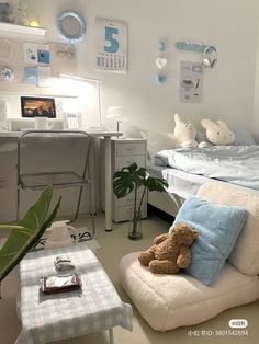 a teddy bear sitting on top of a white chair next to a bed in a bedroom