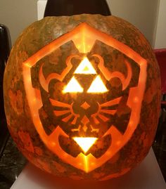 a carved pumpkin with the legend of zelda symbol on it