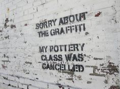 graffiti on the side of a white brick wall that says sorry about the graffitti my pottery class was changed