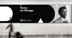 a black and white photo of a man walking past a sign that says, three on change