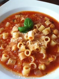 a white plate topped with pasta and sauce