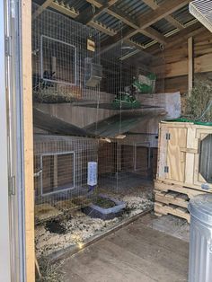 the inside of a caged in animal house with various cages on top of it