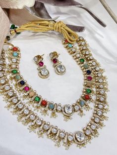 The handcrafted Navratan Polki layered necklace set is based on gold plating that celebrates the rich heritage of Indian jewelry. The Indian Polki necklace set is a masterpiece inspired by Bollywood jewelry to give you a royal look. The bold and bright design of the necklace is perfect for all the beautiful brides to be! *It's Handmade Indian Polki Kundan Necklace Set  * It's Handmade Kundan Stones Settings and 22k gold Plating as shown in picture. * It is Pure Ethnic Look with Antique Touch . s Festive Gold Temple Necklace With Multi-stone, Gold Kundan Multi-stone Temple Necklace, Gold Multi-stone Kundan Temple Necklace, Traditional Gold Multi-stone Necklace, Gold Multi-stone Temple Jewelry Bridal Necklace, Festive Gold Necklace With Stone Work, Multi-stone Necklace For Wedding And Diwali, Festive Gold Necklaces With Stone Work, Celebration Multicolor Kundan Necklace Gold Plated