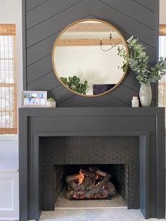 a fireplace with a mirror above it