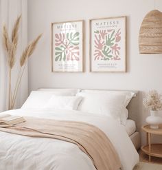 a bedroom with two posters above the bed