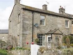 an old stone house is shown in the country side