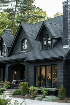 a house with black shingles and windows