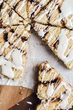 a close up of some food on a cutting board with white icing and brown sugar