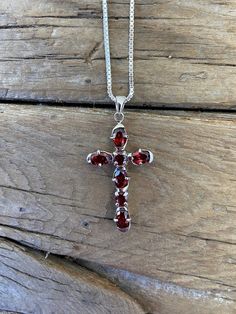 Beautiful red garnet cross necklace...1 9/16" tall with bail by 13/16" wide at the widest spot, cast in sterling silver 925 with five 4mm by 6mm oval shape and two mm by 4mm round garnet stones...the chain is 18" long also in sterling silver 925 with a lobster catch, all the garnet stones a well matched Red Cross Necklace, Arrow Earrings, London Blue Topaz Ring, Garnet Stone, Dragon Pendant, Amber Jewelry, Blue Topaz Ring, London Blue Topaz, Stunning Jewellery