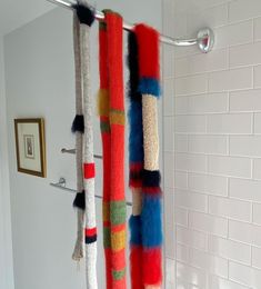 the shower curtain is decorated with multi - colored yarns