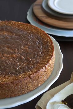 a chocolate cake sitting on top of a white plate