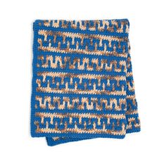 a blue and brown crocheted dishcloth on a white background