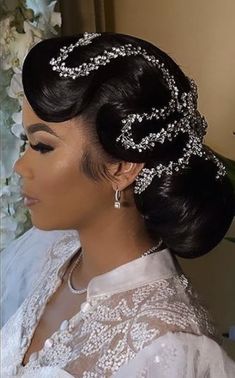 a woman wearing a bridal hair piece with pearls on the side and flowers in the background