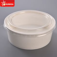 an empty plastic container with lid on a gray background