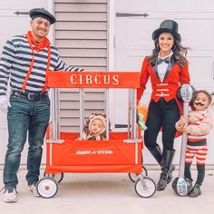 a man and woman in costumes standing next to a cart