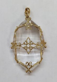 14 Karat Yellow Gold Caged Quartz Crystal Pendant : * 14 KARAT YELLOW GOLD , CAGED QUARTZ CRYSTAL PENDANT . * WEIGHTS 20.9 GRAMS . * IT IS ABOUT 60 MM HEIGHTS WITH BAIL , AND 33 MM WIDE. * THE BAIL CAN BE OPEN TO INSERT THE CHAIN  IN. * PREOWNED, IN GEAT CONDITION. Elegant Necklace With Large Clear Pendant, Elegant Clear Necklace With Large Pendant, Elegant Clear Pendant Jewelry, Quartz Crystal Pendant, Topaz Pendant, Beaded Pendant, Gold Yellow, Crystal Pendant, Quartz Crystal