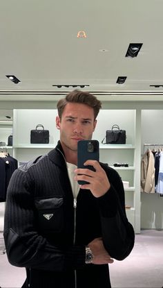 a man taking a selfie in a clothing store