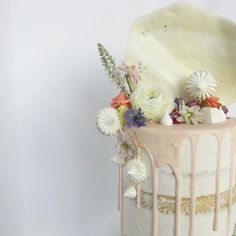 a white cake with flowers and icing on top