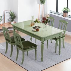 a green table and chairs in a room