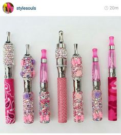 five different types of pink and silver pens with flowers on them, all lined up in a row